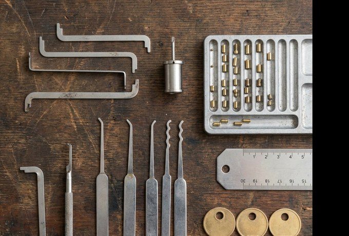 Locksmith tools and equipment laid out on a service van workbench